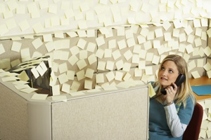 girl srrounded by post-its in an office