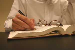 person writing in a book